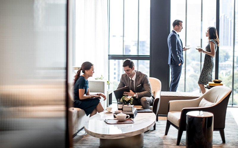 Business travelers working in a hotel lobby.