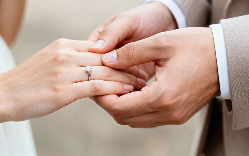 Close-up of a romantic wedding proposal over a dinner.